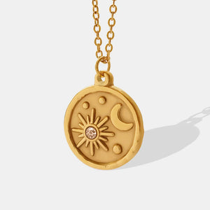 Gold zirconia coin necklace with sun, moon and star details.
