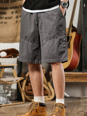 Men's gray drawstring shorts, relaxed fit, with buttoned cargo pocket detail.