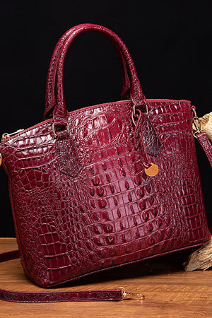 Deep Red crocodile embossed satchel bag with top handle and gold hardware detail.