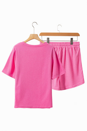 Cerise waffle knit lounge set with short sleeves and elastic waist shorts.