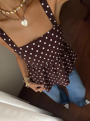 Brown polka dot tie-back cami with ruffled hem, paired with jeans.