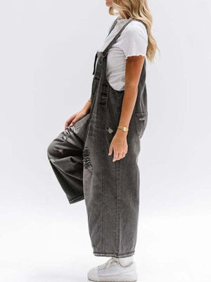 Ripped relaxed fit denim overalls in dark blue with distressed details and adjustable straps.