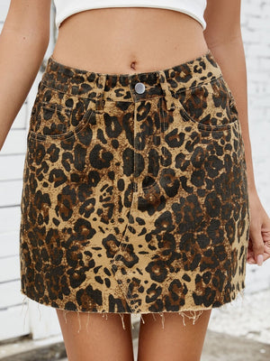 Leopard print denim skirt with raw hem and five-pocket styling.