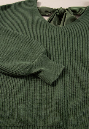 Dark green ribbed knit sweater with a V-neck and satin bow tie back detail.