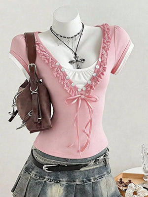 Pink maternity t-shirt with white trim, ruffled neckline, button details, and bow tie.