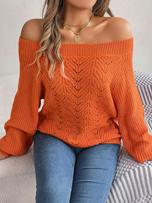 Open-knit off-shoulder sweater in pumpkin with voluminous sleeves and chevron pattern.