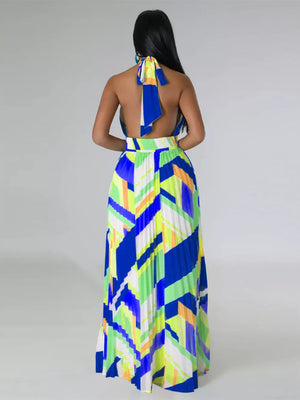 Halter neck maxi dress with geometric print and pleated skirt in blue, green, and yellow.