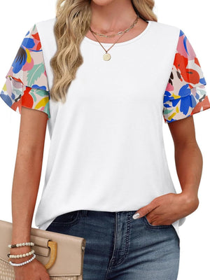 White t-shirt with layered ruffled short sleeves featuring a multicolor floral print.