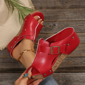 Red open-toe wedge sandals with buckle detail and cork platform.