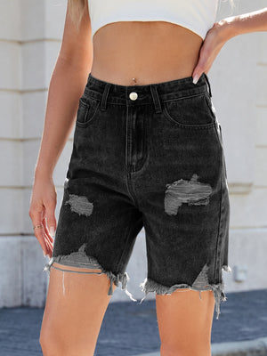 Black distressed denim Bermuda shorts with frayed hem and rips.