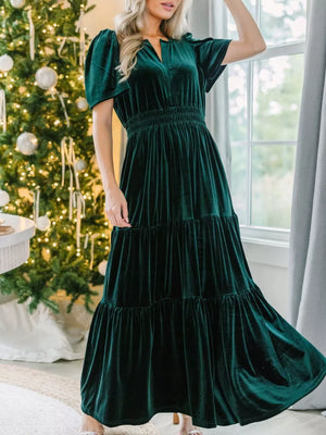 Dark green velvet maxi dress with tiered skirt and smocked waist.