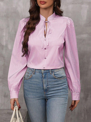 Pink striped blouse with puffed sleeves and keyhole neckline.