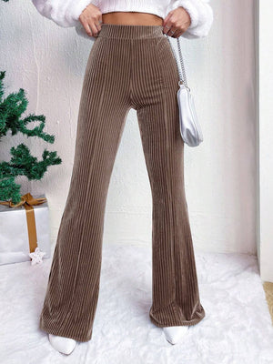 Textured corduroy bell bottom trousers in camel with vertical ribbing.
