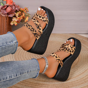 Leopard print platform wedge sandals with double straps and a black textured wedge heel.