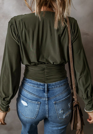 Army green draped bodice wrap bodysuit with ruched waist detail and long sleeves.