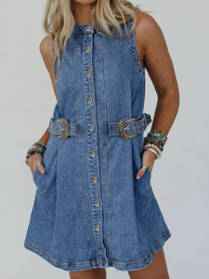 Belted denim dress with button front, pockets, and ornate buckle details.