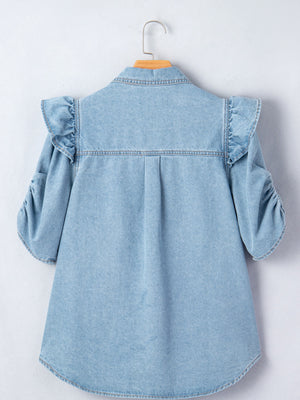 Light wash denim button-down shirt with ruffled shoulders and ruched sleeves.