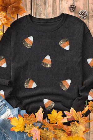 Black ribbed knit top with allover candy corn embellishments.