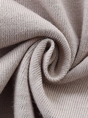Close up of beige cotton knit fabric detail on a baby t-shirt.