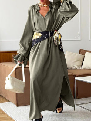 Army green cotton maxi dress with tie neck, ruffled sleeves, and side slits.