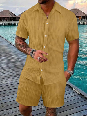 Textured resort shirt and shorts set in gold with vertical pleats and button front.