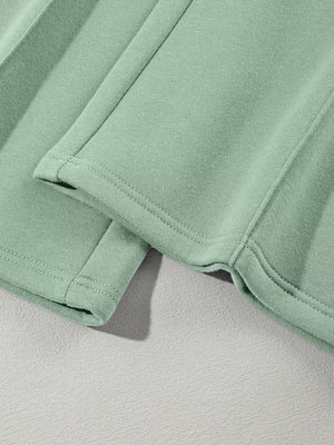 Sage cotton joggers with double-stitched hem detail and side seam.
