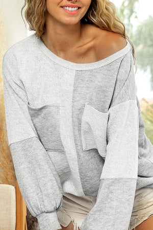 Colorblock sweatshirt in light gray with two front pockets and a slouchy fit.