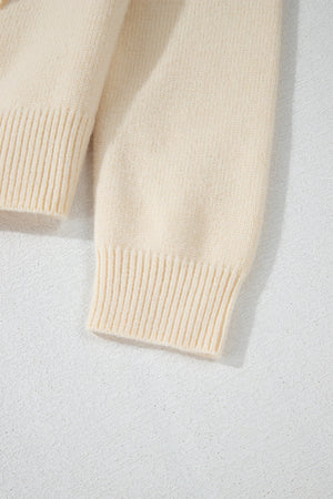 Ivory bouclé knit cardigan with ribbed cuffs and hem detail.