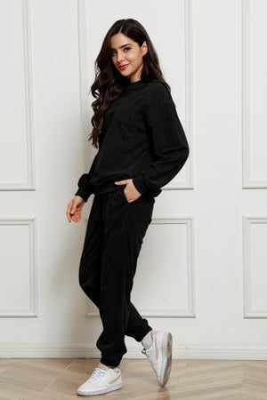 Black corduroy lounge set with crew neck sweatshirt and pocket detail pants