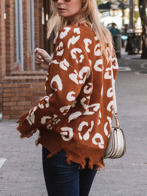 Brown leopard print knit sweater with raw edge hem and distressed details.