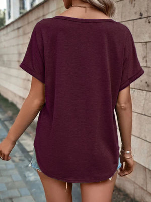 Buttoned V-neck short sleeve t-shirt in dark red with decorative buttons, cuffed sleeves.