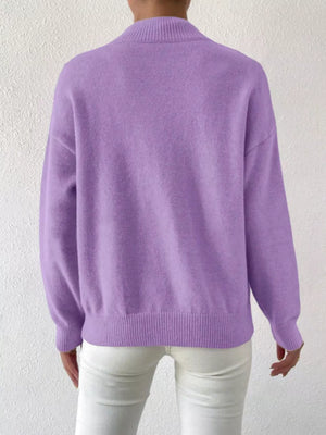 Lavender mock neck knit sweater with dropped shoulders, ribbed cuffs and hem.