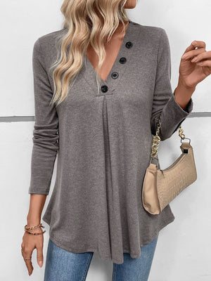 Gray button-placket tunic with subtle pleats and a V-neck.