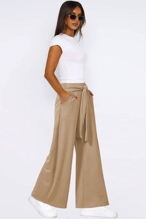 Tan soft drape palazzo trousers with tie waist and pockets.