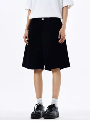 Black chino shorts with drawstring detail, mid-thigh length.