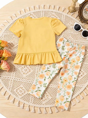 Light yellow ruffle top with puff sleeves and floral print leggings.