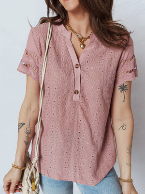Pink eyelet embroidered short-sleeve blouse with button-down neckline and cutout details.