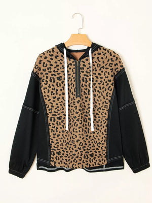 Leopard print zip hoodie with black sleeves and white drawstrings.