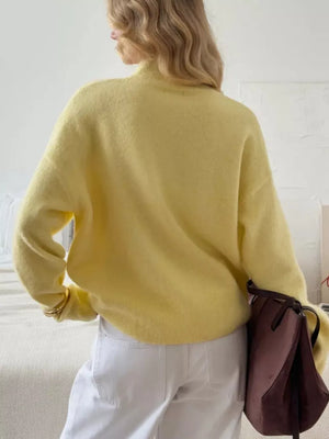 Relaxed mock neck knit sweater in pastel yellow acrylic blend, shown from the back.