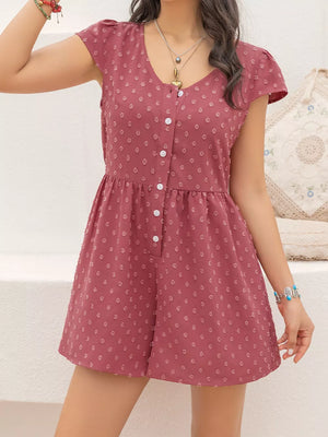 Maternity romper in rose with Swiss dots, cap sleeves, V-neck, and button-down front.