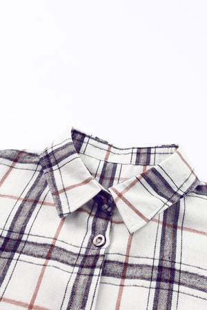 Oversized shacket with white, navy, and rust plaid pattern, featuring a collared neckline and button detail.