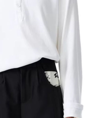 Men's black wide-leg trousers with a patterned pocket detail.