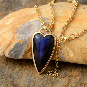 Gold chain necklace with a heart-shaped labradorite pendant and adjustable clasp.