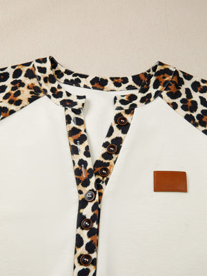 Buttoned blouse with leopard print collar and placket, beige body, and brown buttons.