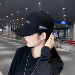 Black cotton baseball cap with white embroidery detail and text.