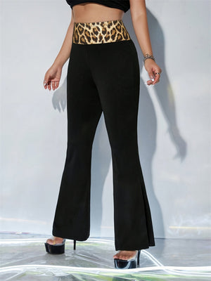 Black flare trousers with a bold leopard print waistband.