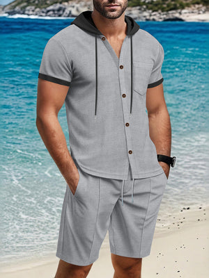 Grey short sleeve hooded button-down shirt with pocket and matching drawstring shorts.