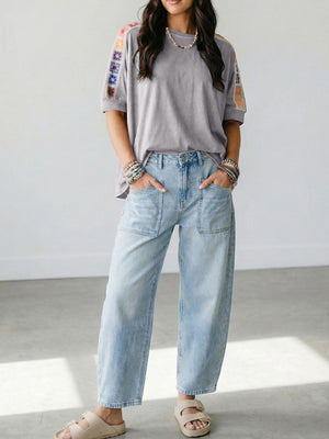 Grey t-shirt with colorful crochet detail on sleeves, loose fit, crew neck.