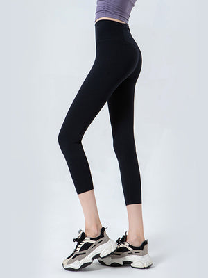 Black sculpted crop leggings with a high waistband and mesh detail.