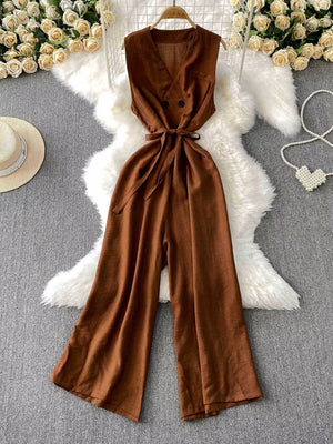 Brown V-neck wide leg jumpsuit with belted waist and button detail